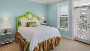 A bedroom with a bed, two bedside tables, a window with blinds, and a door. - Close to Beach Access & Rosemary~ Seacrest Lagoon Pool Access (Panama City Beach)
