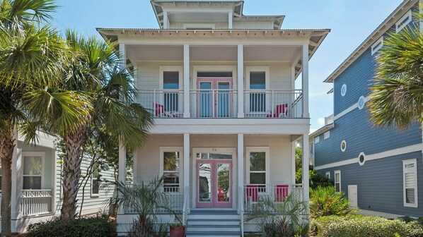 A two-story house with a balcony, a front door, and a small porch. - Close to Beach Access & Rosemary~ Seacrest Lagoon Pool Access (Panama City Beach)