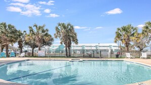 A clear swimming pool with a no diving sign, surrounded by palm trees and lounge chairs. - Carols Coastal K502 3 Bedroom Condo by RedAwning (Rockport)