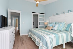 A bedroom with a bed, dresser, and a television on a stand. - Mom's Gift / 256-b Brunswick Ave West 2 Bedroom Home by RedAwning (Supply)