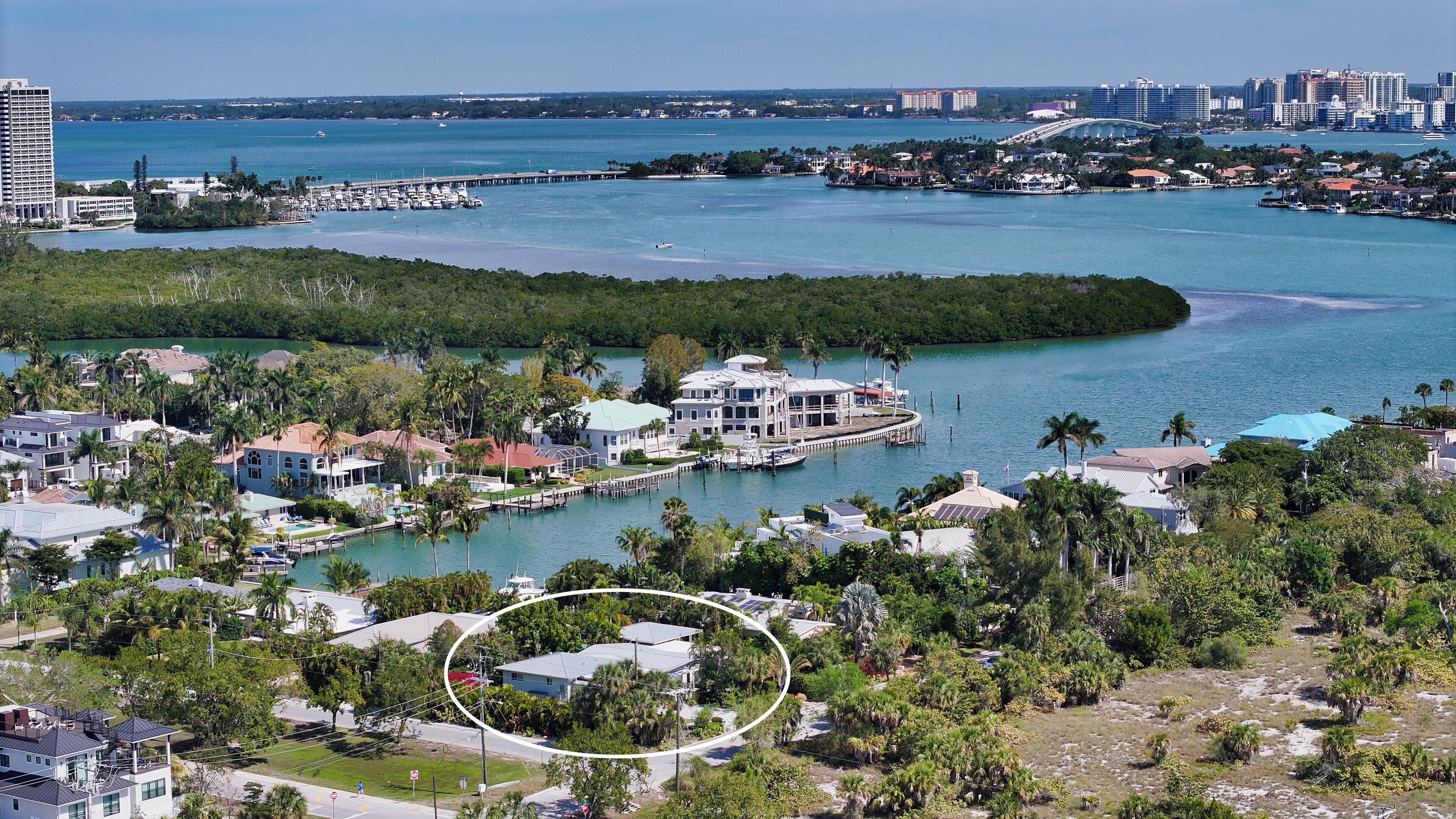A coastal area with a marina, waterfront properties, and a large building in the background.