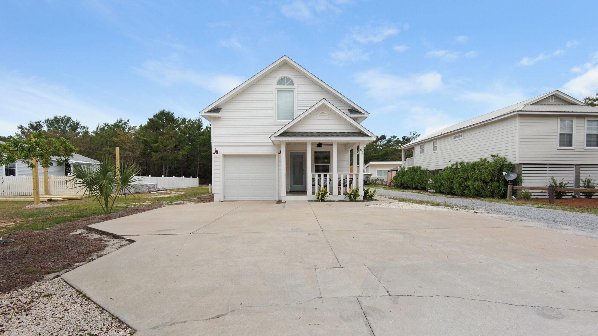 A single-story house with a front porch, a garage, and a driveway.
