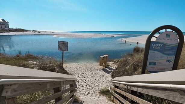 A beach access sign and a safety notice board at South Walton. - Fully Updated Beach Retreat; Minutes to Eastern Lake & Beaches (Santa Rosa Beach)
