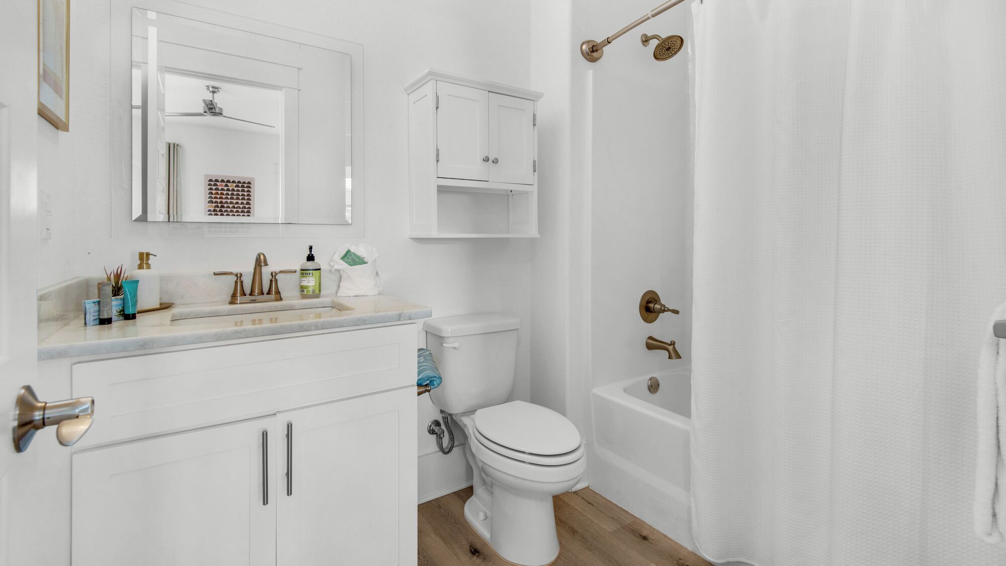 A modern bathroom with a toilet, sink, and shower.