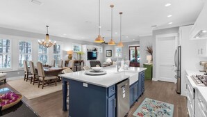 A modern kitchen with a central island, built-in appliances, and pendant lighting. - Grayton Beach - Gated Community With 2 Pools & Tennis (Santa Rosa Beach)
