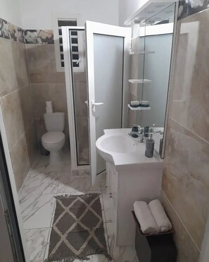 Shower, hair dryer, towels, soap