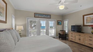 A bedroom with a bed, a TV, a dresser, and a ceiling fan. - Gulf Front in Seagrove - Amazing Views - Easy Beach Access, Pool (Santa Rosa Beach)