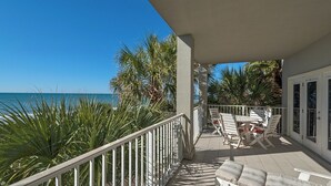 A balcony with a view of the ocean, white outdoor furniture, and palm trees. - Gulf Front in Seagrove - Amazing Views - Easy Beach Access, Pool (Santa Rosa Beach)