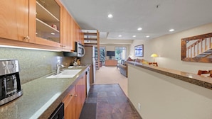 A modern kitchen with granite countertops, wooden cabinets, and stainless steel appliances. - 348 | Refreshed Loft - Full Fridge + Pool Vibes (Olympic Valley)