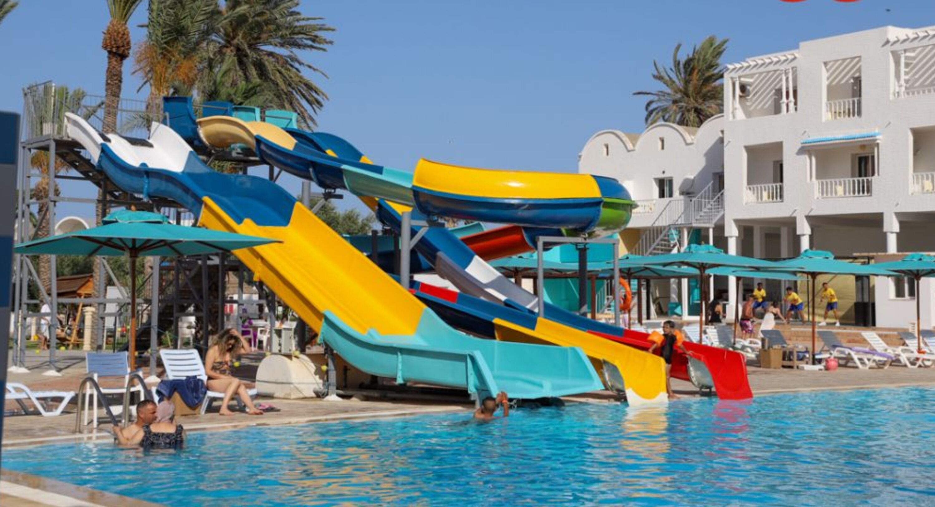 A water park with multiple slides and a pool area.