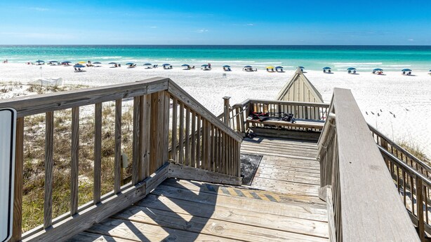 A wooden boardwalk leading to a beach with white sand and clear blue water. - Beach House 104A - Gulf Front Resort! (Miramar Beach)