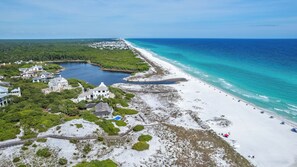 An aerial view of a coastal area with a beach, a small lake, and residential buildings. - 3br/2.5ba, Sleeps 8, Private Beach Access! (Santa Rosa Beach)