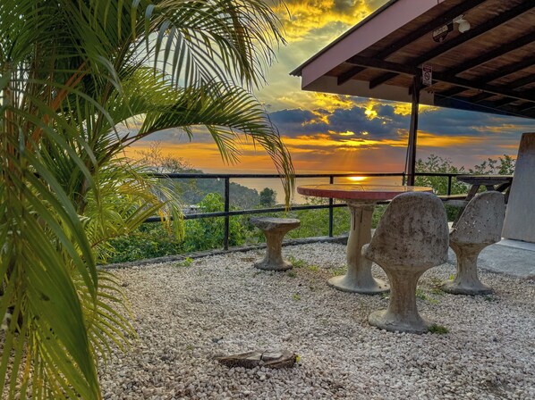 Relax in a tranquil outdoor seating area with a stunning view of the water.