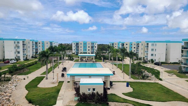 A resort with multiple buildings, a central pool, and landscaped areas. - Relaxing II, Punta Cana near beaches ✅ (Punta Cana)