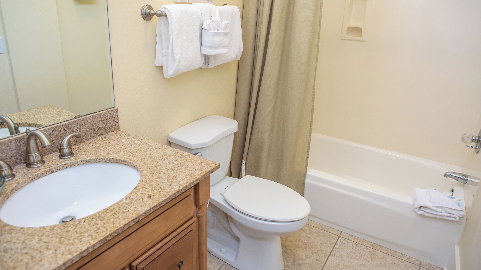 A bathroom with a sink, toilet, and bathtub.