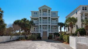 A multi-story building with a symmetrical facade, balconies, and a gated entrance. - Luxury 4-bedroom Vacation Home With Unparalleled Gulf Views (Santa Rosa Beach)