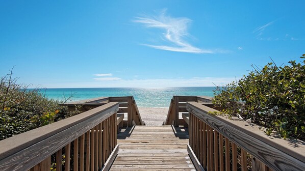 A wooden boardwalk leading to a beach with clear blue water and a bright sky. - Luxury 4-bedroom Vacation Home With Unparalleled Gulf Views (Santa Rosa Beach)