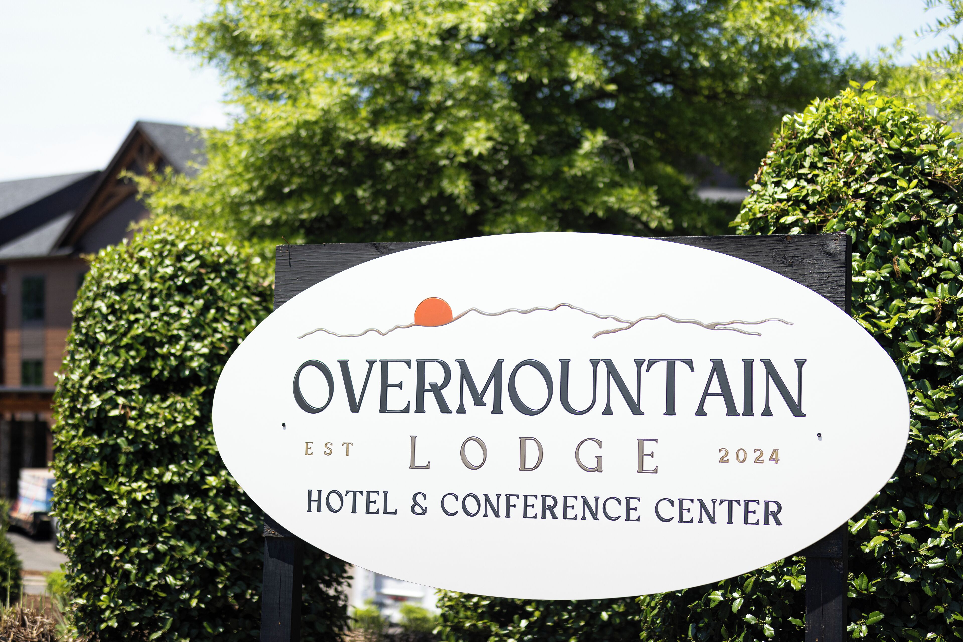 A sign for Overmountain Lodge, indicating it is a hotel and conference center established in 2024.