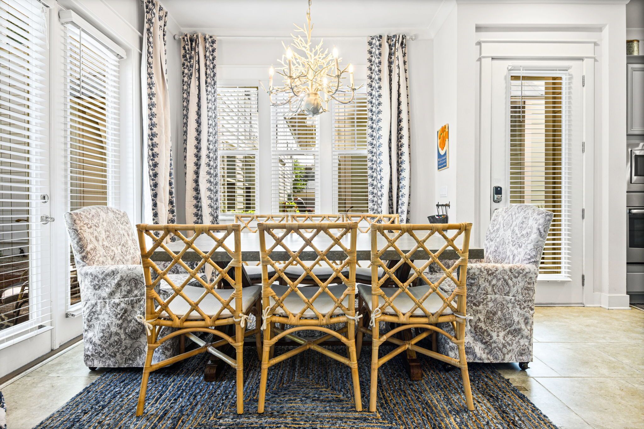A dining area with a table, chairs, and a chandelier.