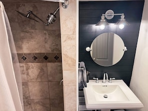 Shower, hair dryer, towels, shampoo