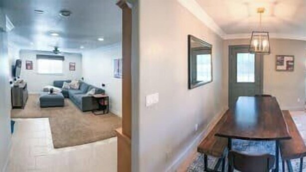 A spacious living area with a dining table, a kitchen with modern appliances, and a large window providing natural light.