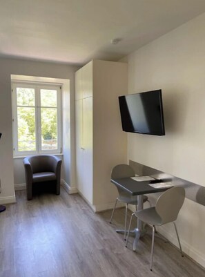 Relax in this stylish room with a flat-screen TV, dining table, and comfortable seating area.