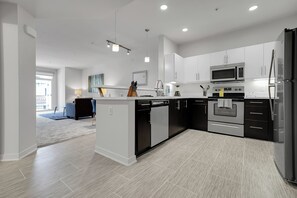 Enjoy cooking in this well-lit kitchen with appliances and sleek cabinetry.