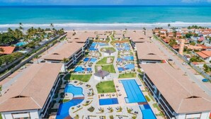 A resort with multiple swimming pools, a central courtyard, and beachfront views. - Cupe Beach Living Porto de Galinhas (Ipojuca)