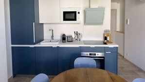 A compact kitchen with a sink, microwave, toaster, and oven.