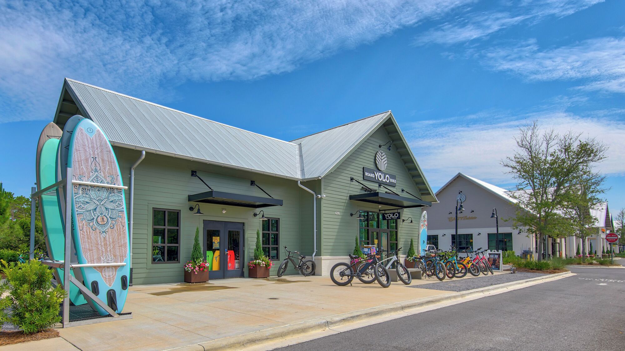 A building with a green facade and a sign for 'Board YoYo Bike'.
