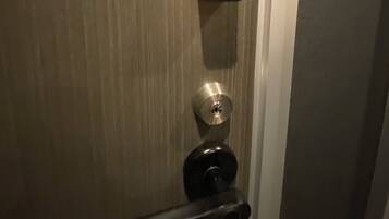 A door with a keypad lock and a keyhole.