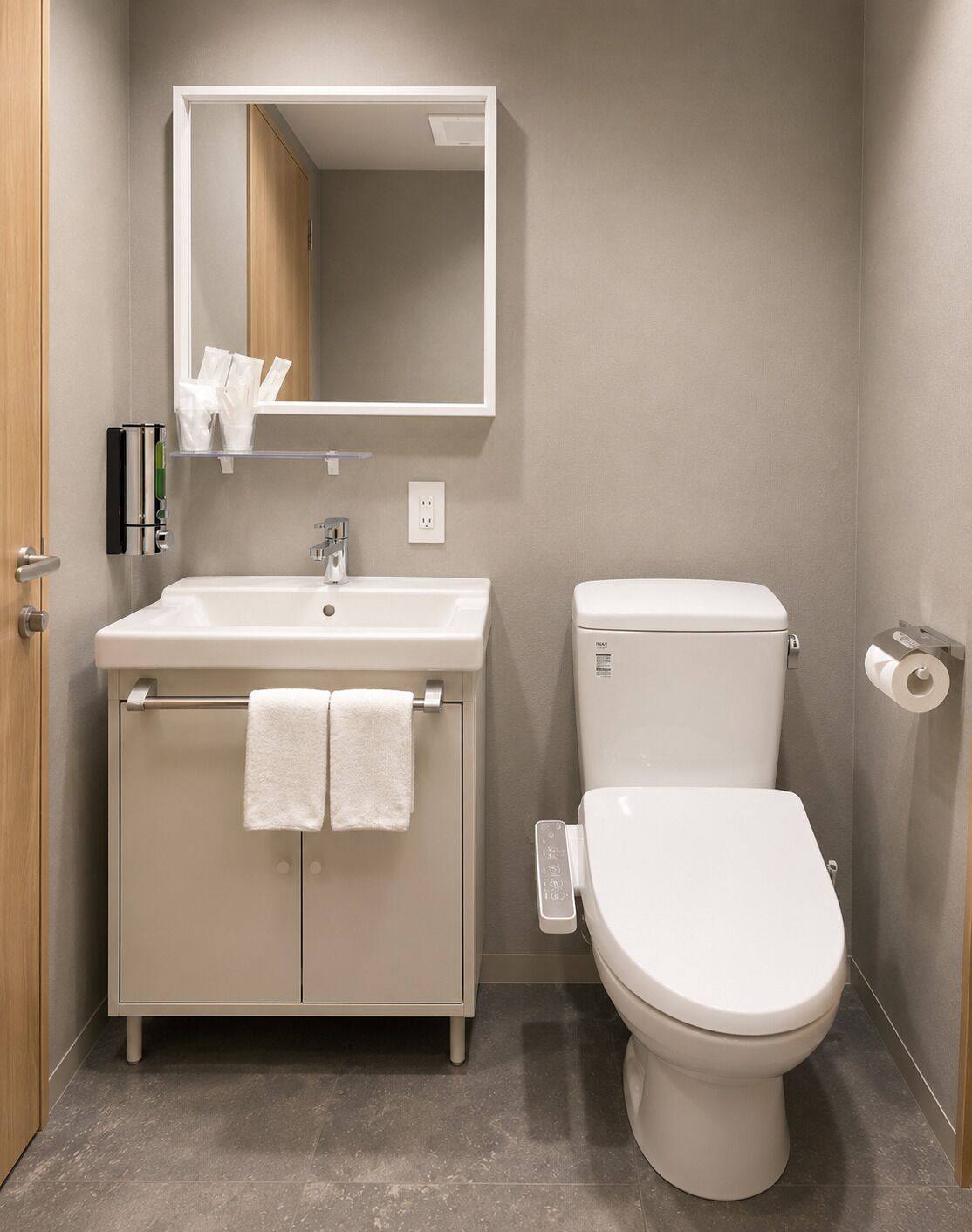 A bathroom with a toilet, sink, and mirror.