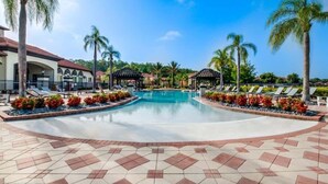 A swimming pool with lounge chairs and palm trees. - *NEW* Super Amazing Vacation Getaway (Kissimmee)