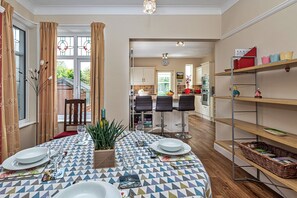Enjoy meals in the spacious dining area with a large window and comfortable seating.