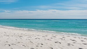 A sandy beach with footprints leading to the water. - Spacious 4BR With 2 Master Suites, Golf Cart, .3 Miles to Beach - Sleeps 15 (Santa Rosa Beach)