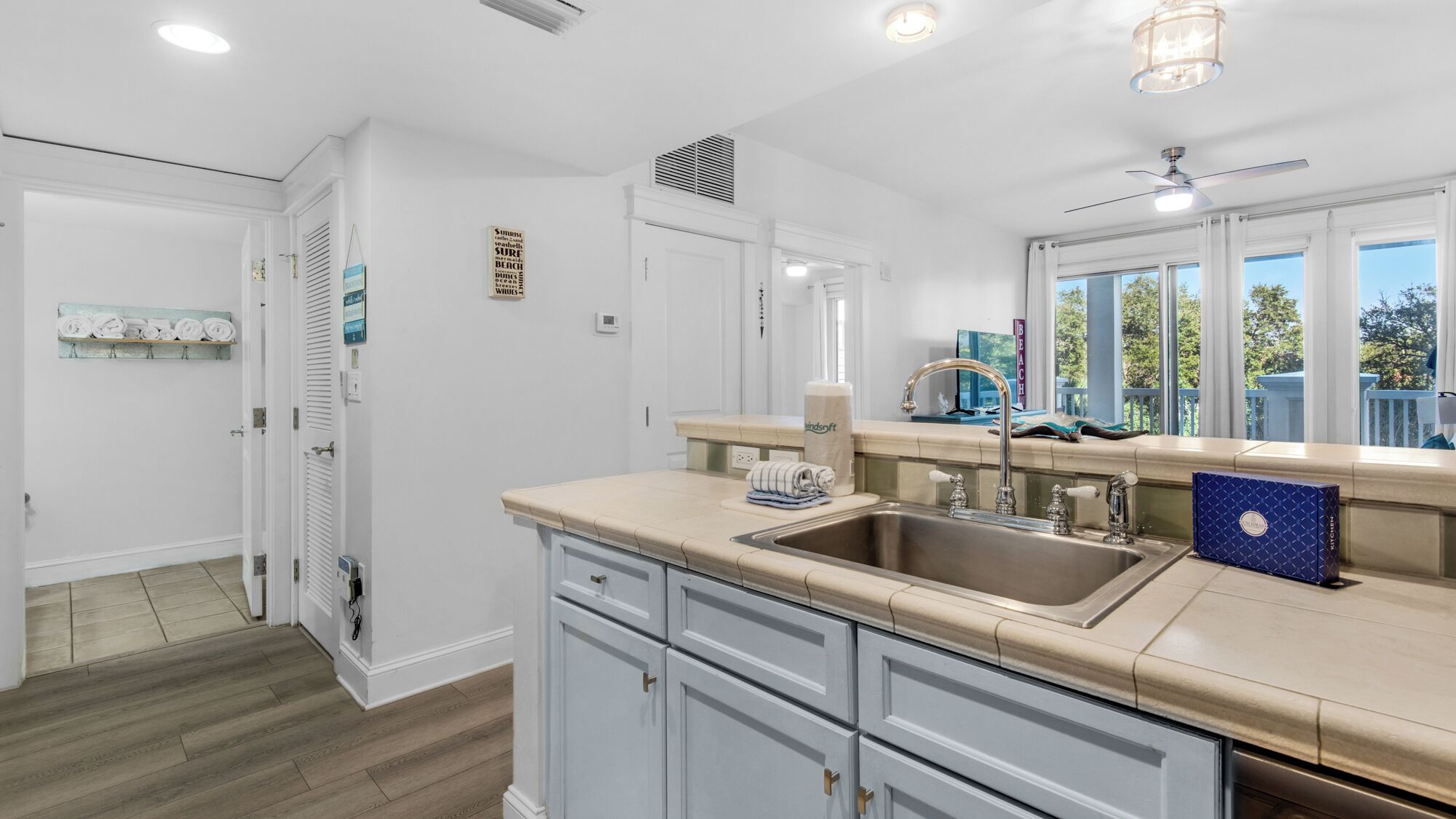 A modern kitchen with a sink, countertop, and cabinets.
