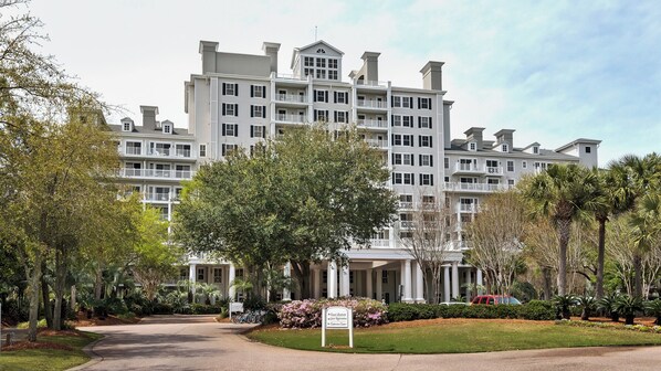 A large, multi-story hotel with a symmetrical facade, featuring balconies and a central entrance with columns. - Steps From Baytowne Wharf With Pool & Private Beach Access (Miramar Beach)