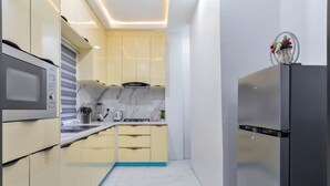 A modern kitchen with a built-in microwave, stove, and refrigerator.