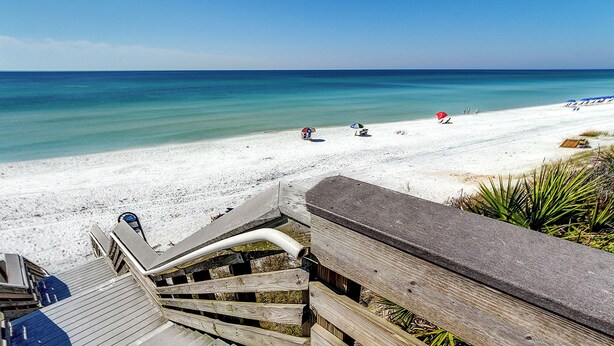 A wooden staircase leading down to a beach with a clear view of the ocean. - Beachwood Villas (Santa Rosa Beach)