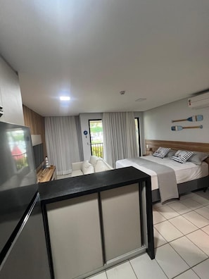 Une chambre d’hôtel moderne équipée d’un lit, d’un bureau et d’une télévision.