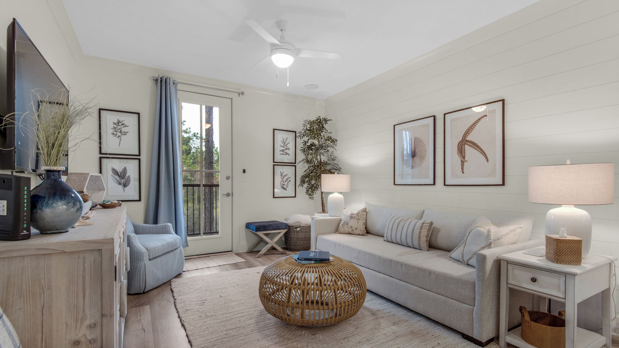 A modern living room with a sofa, a coffee table, a side table, and a TV.