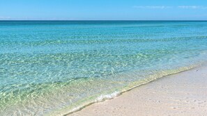 A beach with clear shallow waters and a sandy shore. - San Remo (Santa Rosa Beach)