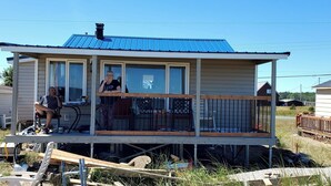 A small, single-story house with a blue roof and a balcony. - Beachlife...time to relax! (Beresford)