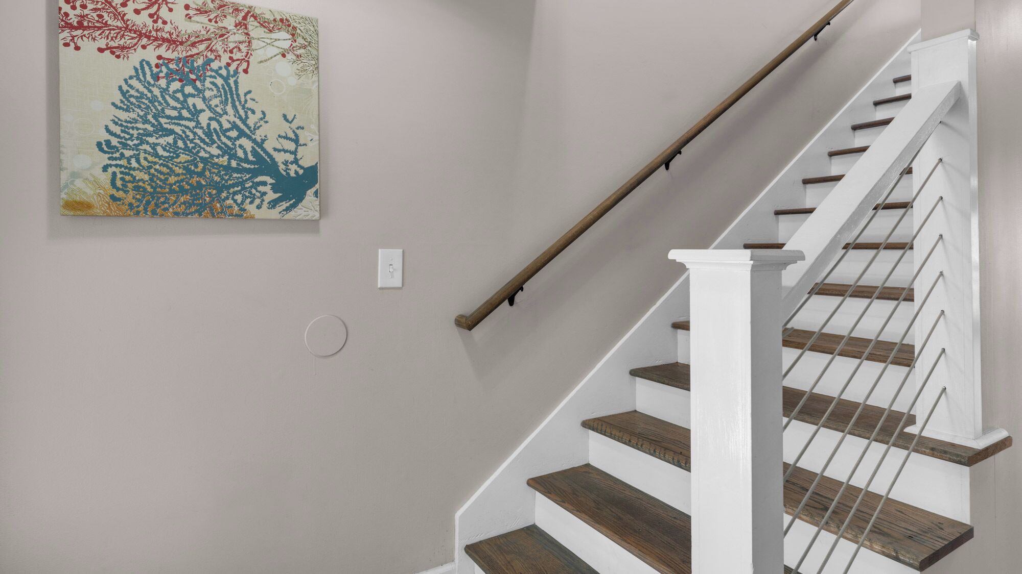 A staircase with white railings and wooden steps.