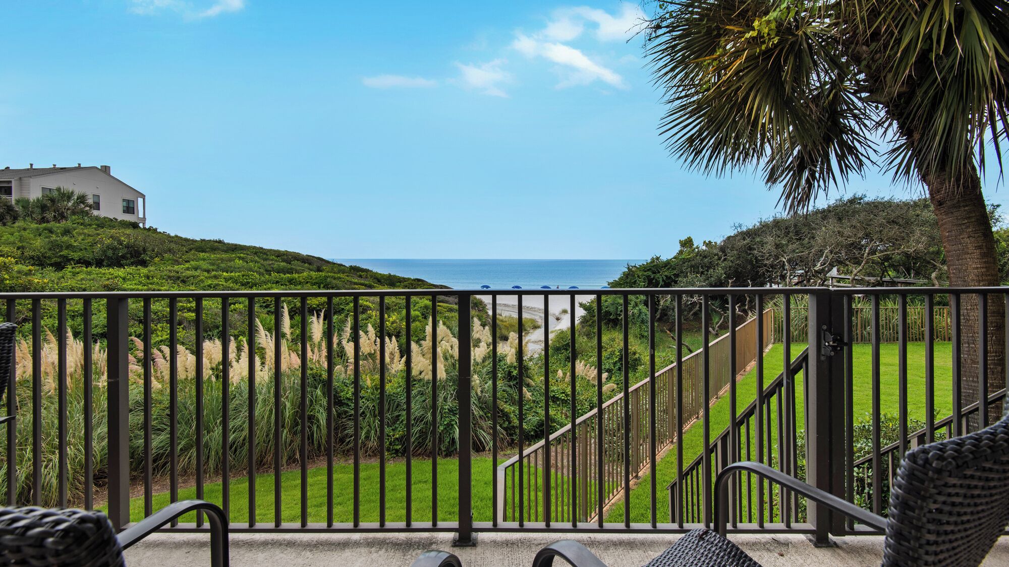 Ein Balkon mit Blick auf Strand und Meer.