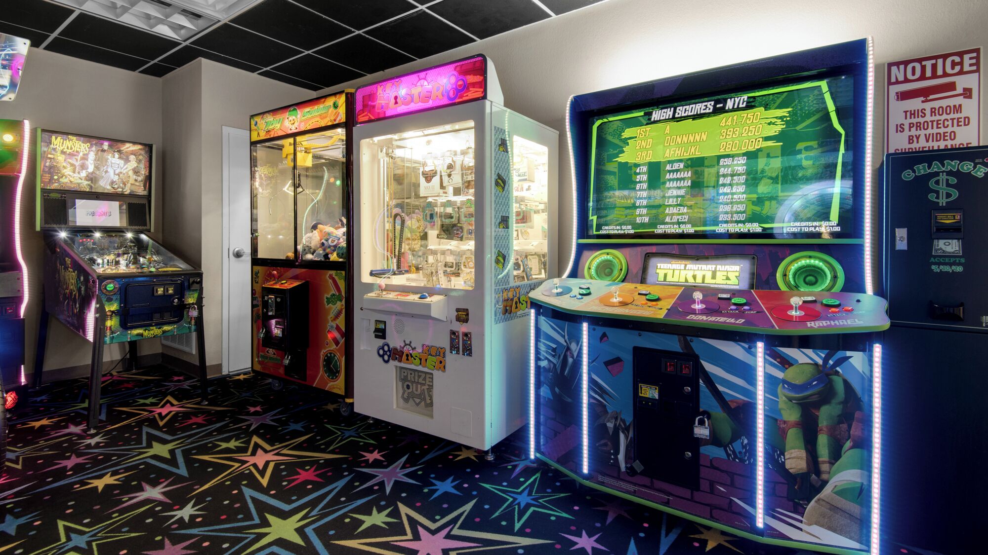 A gaming arcade with various machines, including a 'Turtles' game and a 'Key Master' machine.