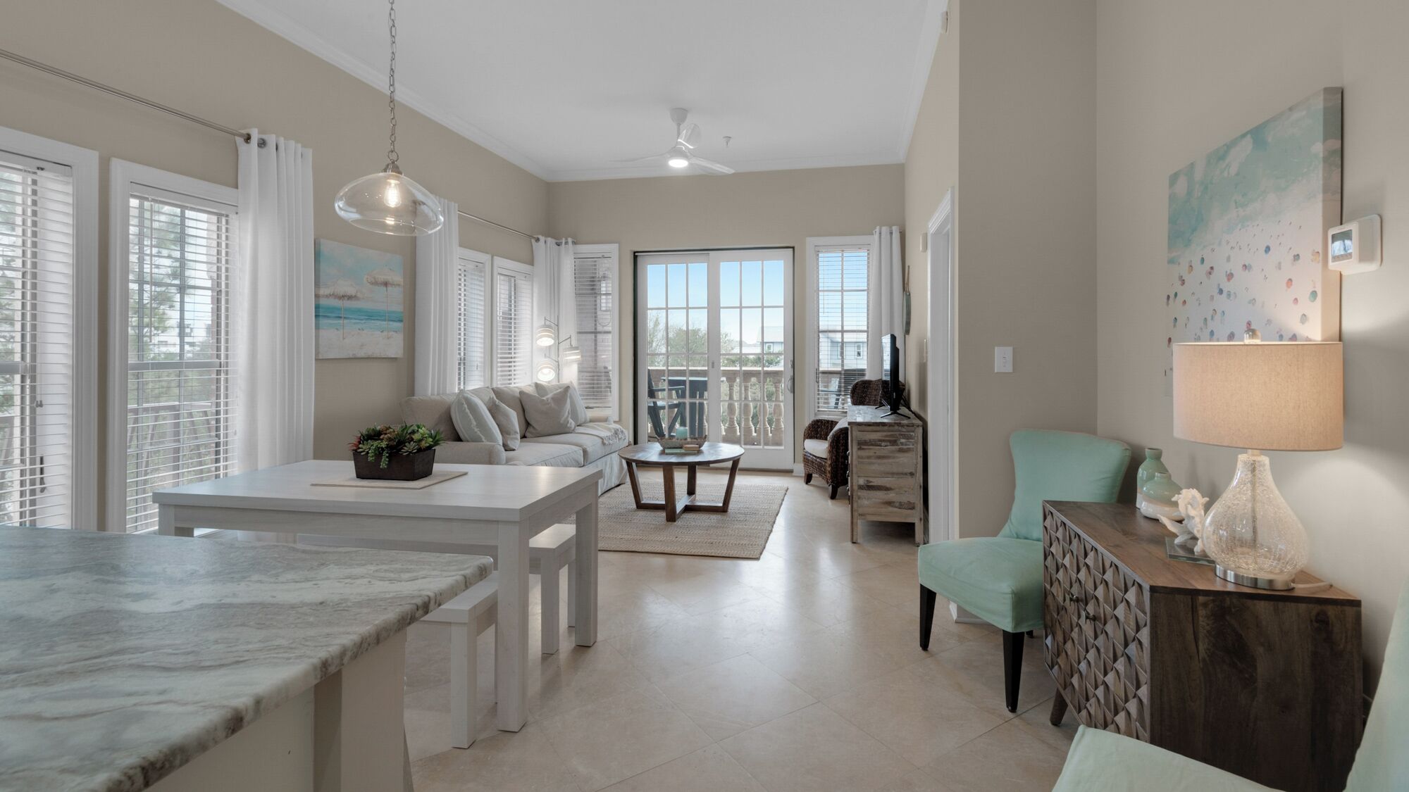 A spacious living area with a kitchen, dining table, and seating.