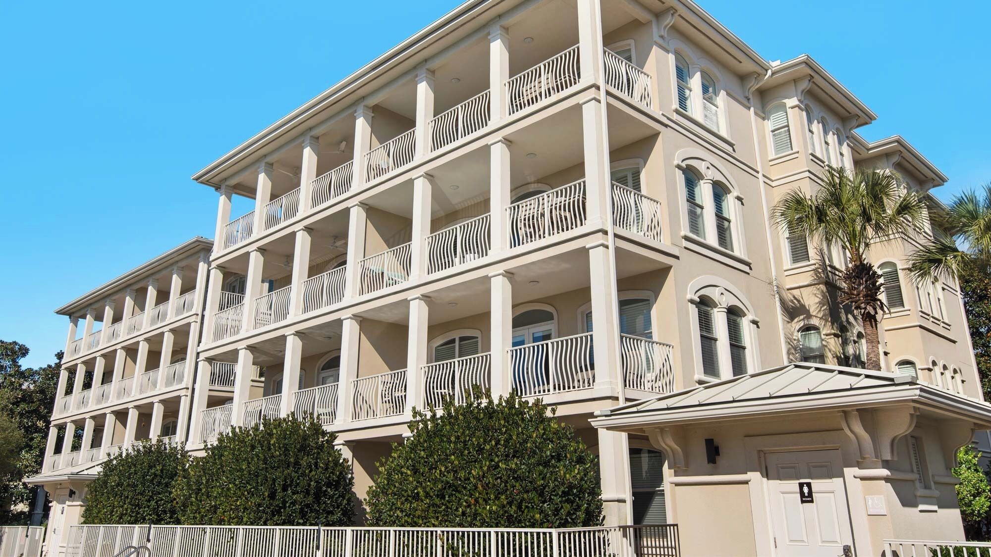 A multi-story building with balconies and a classic architectural style.