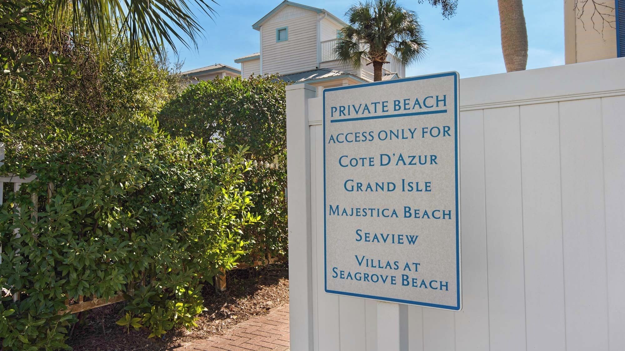 A sign indicating a private beach with access only for specific locations.