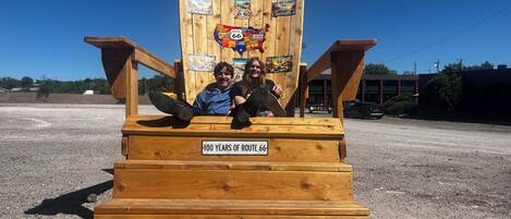 A wooden structure with a sign indicating '100 YEARS OF ROUTE 66' and 'MOTEL ENTRANCE' pointing to the right.